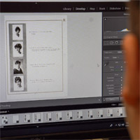 A student edits an image of a Western College for Women Multifaria yearbook on a computer using Adobe Lightroom software.